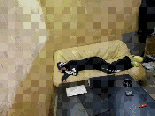 a person laying on a couch with the word slam written on their pants