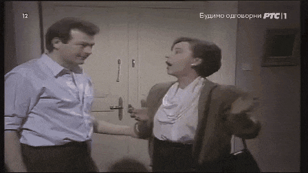 a man and a woman are standing in front of a door with ptc 11 on the bottom right