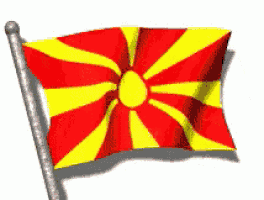 a red and yellow flag with a yellow center is waving in the wind