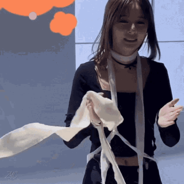 a woman with a scarf around her neck has the letters zvc on the bottom