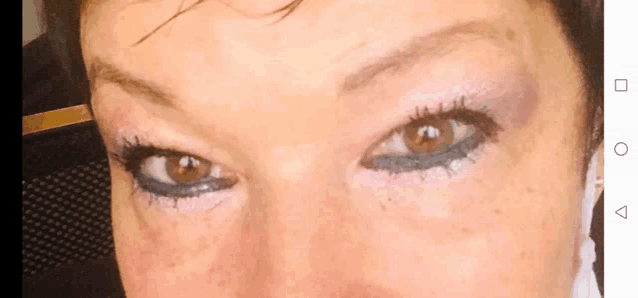 a close up of a woman 's eye with a black eye