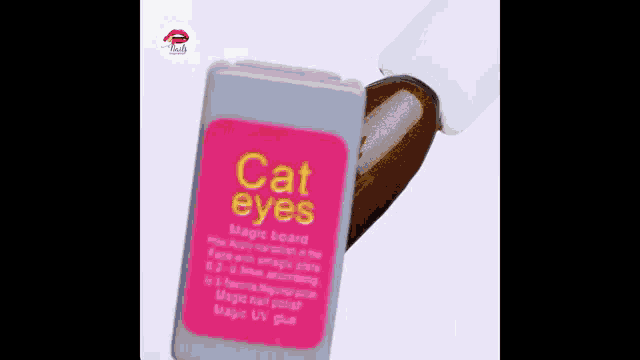 a bottle of cat eyes magic board nail polish is being applied to a nail .