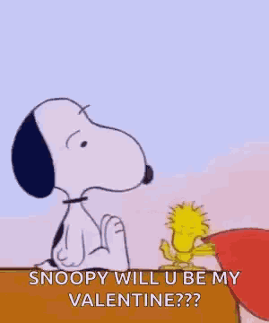 snoopy and woodstock are sitting next to each other holding a heart .