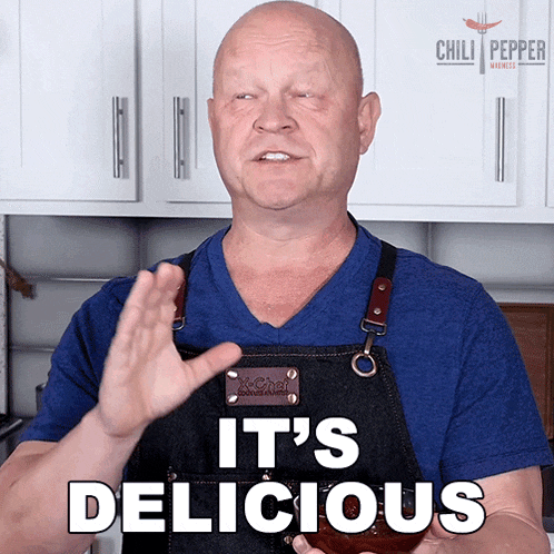 a man in an apron says it 's delicious in front of a chili pepper sign
