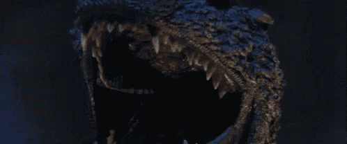 a close up of a monster with its mouth open and sharp teeth .
