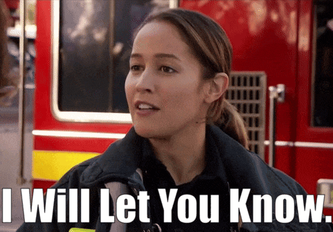 a firefighter says " i will let you know " in front of a red truck
