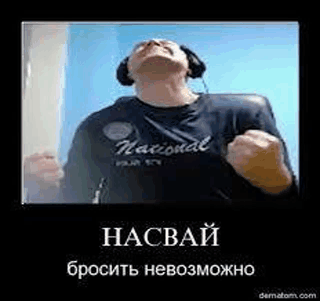 a man wearing headphones and a blue shirt is looking up at the sky .