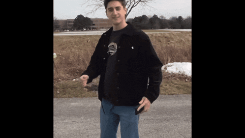 a man wearing a black jacket and a t-shirt with a skull and crossbones on it