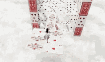 a castle made out of playing cards is sitting on a table .
