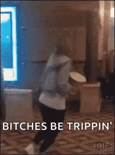 a person is kneeling down in a room with the words `` bitches be trippin '' on the bottom .