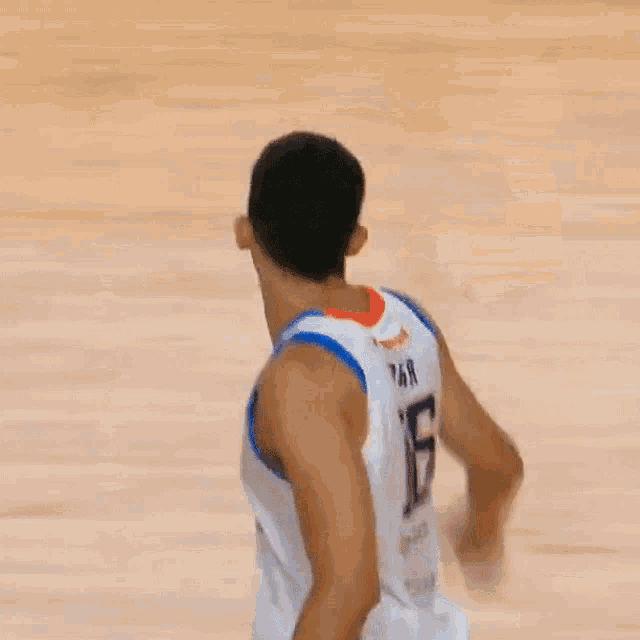a basketball player in a white and blue jersey with the number 7 on it