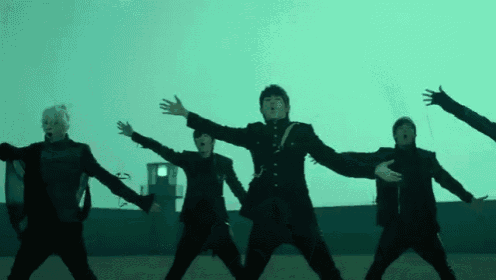 a group of men are dancing in front of a blue sky