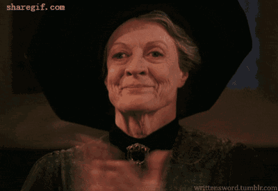 a woman wearing a black hat is clapping her hands in front of a sharegif.com watermark