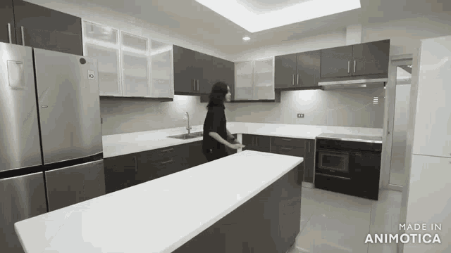 a woman is standing in a kitchen with the words made in animatica on the bottom right