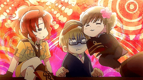 a group of three anime characters are standing next to each other on a table .