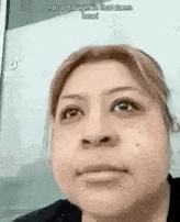a close up of a woman 's face looking at the camera .