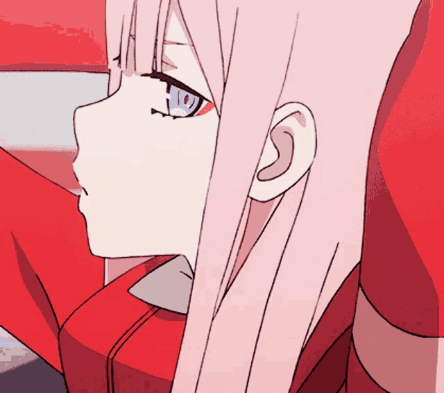 a girl with pink hair and blue eyes looks to the side