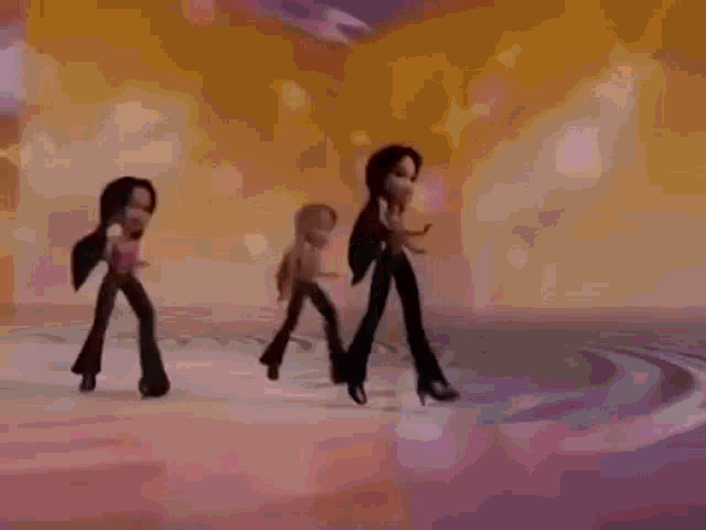 three bratz dolls are dancing on a stage in a video .