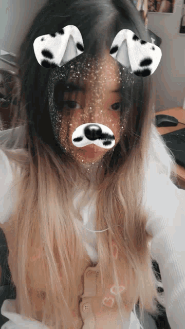 a girl wearing a dalmatian mask takes a selfie