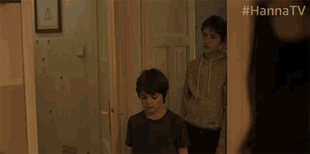 a young boy is looking at a woman with the hashtag #hannatv