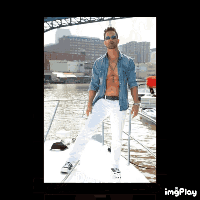 a shirtless man is standing on a boat with the word imgplay in the corner