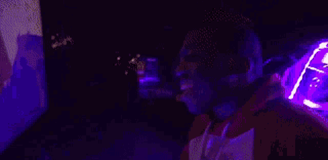 a group of people are standing next to each other in a dark room .