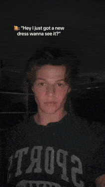 a young man wearing a gray shirt with the word troops on it