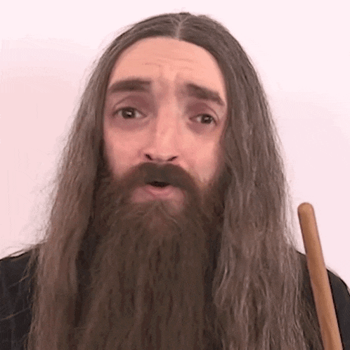 a man with a long beard is holding a cane