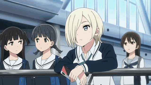 a girl with blonde hair is leaning on a railing while other girls look on