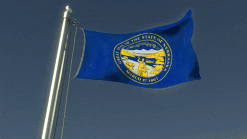 the flag of the state of nebraska is waving in the wind