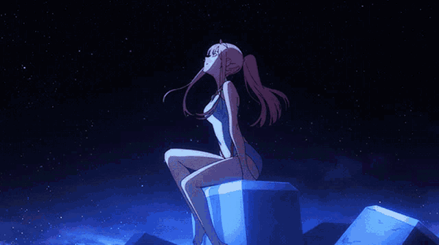 a girl in a bathing suit is sitting on a cube looking up at the stars