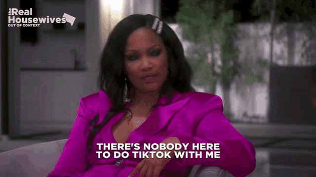 a woman in a purple suit says there 's nobody here to do tik tok with me