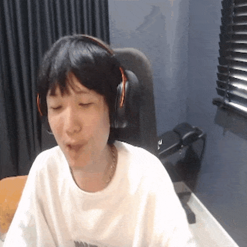 a person wearing headphones and a white shirt that says nike on it