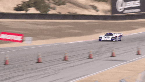 a porsche racing car is driving down a track