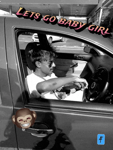 a man is sitting in a car with the words let 's go baby girl written on the side