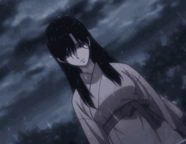 a woman in a kimono stands in the rain with her eyes closed