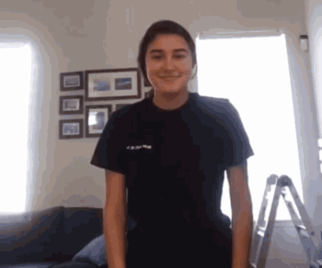 a woman wearing a black shirt that says " crew "