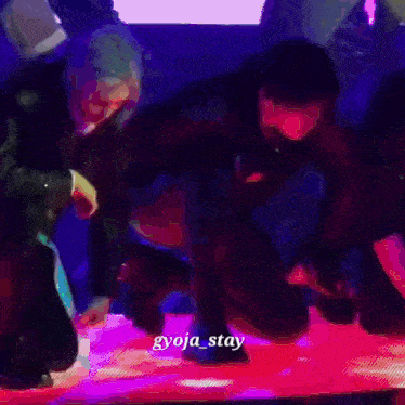 a group of people on a stage with the name gyoja_stay on the bottom right