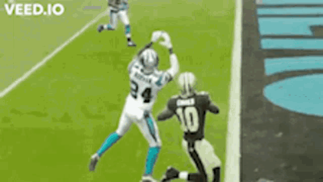 a football player with the number 10 on the back of his jersey is jumping in the air