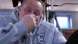 a man wearing a light blue hoodie with the letter l on it