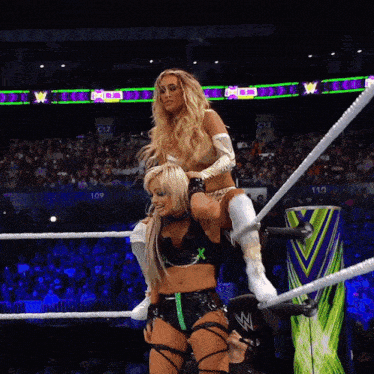 a woman in a wrestling ring with a sign that says go jackets on it