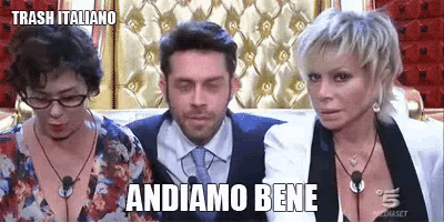 a man and two women are sitting next to each other with the words andiamo bene written on the bottom