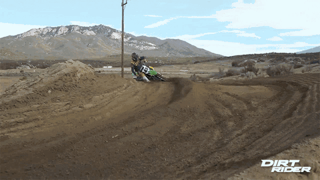 a dirt rider is riding a dirt bike on a track