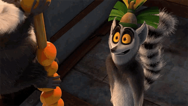 a cartoon lemur with a crown on its head stands next to another lemur