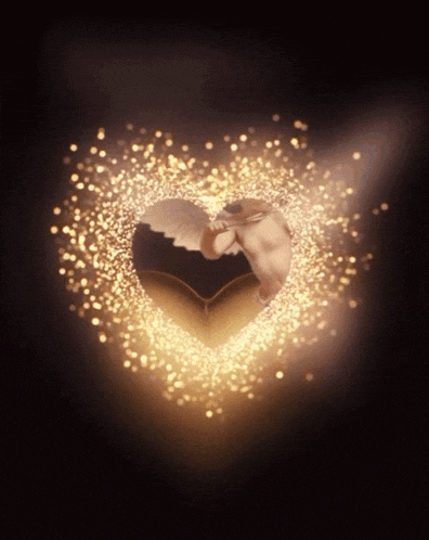 a heart shaped object is surrounded by sparkles on a black background