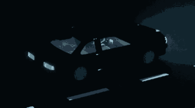 a car is driving down a road at night with a license plate that says t