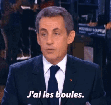 a man in a suit and tie says j ' ai les boules .
