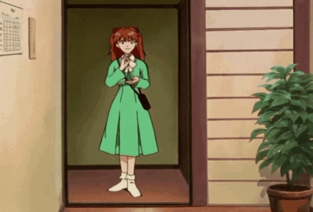 a girl in a green dress is standing in a doorway