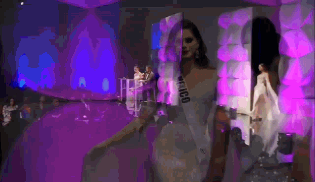 a woman wearing a sash that says mexico is standing on a stage