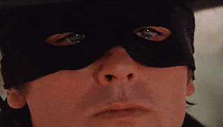 a close up of a man 's face with a black mask on
